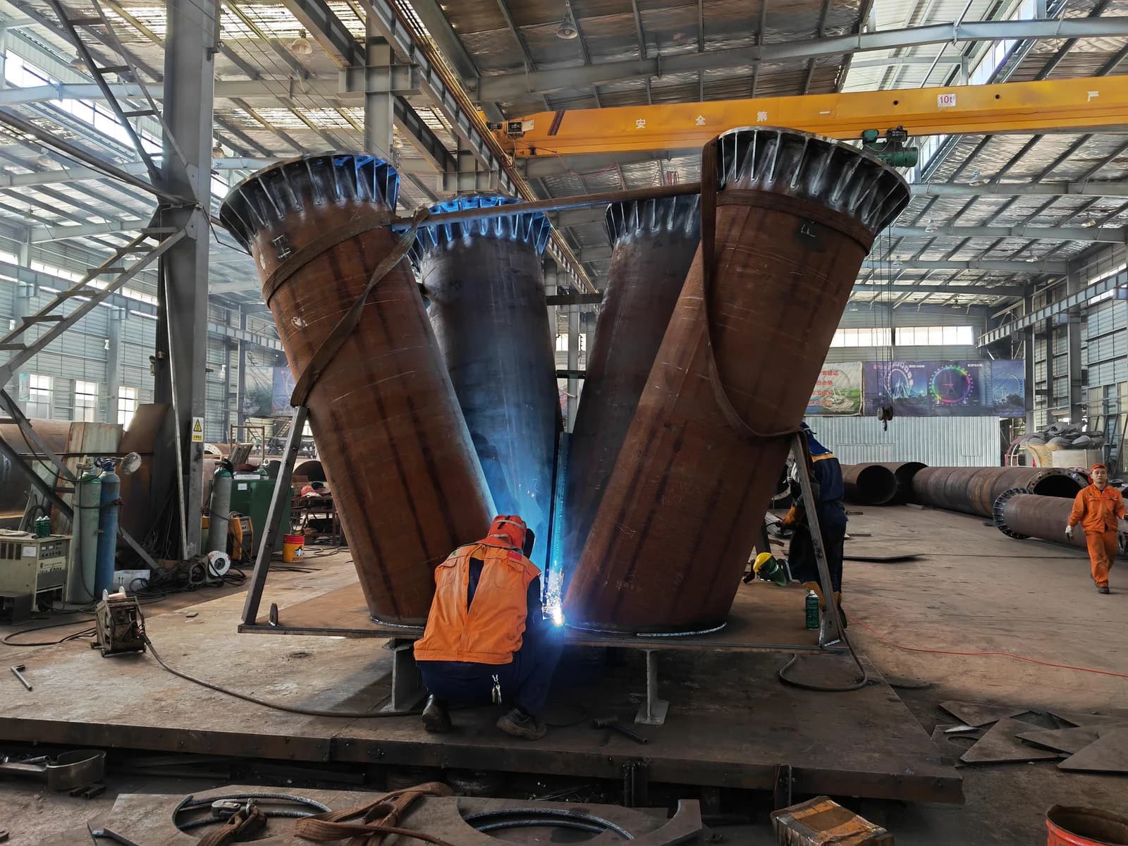 Large steel support components being fabricated inside a Juma workshop