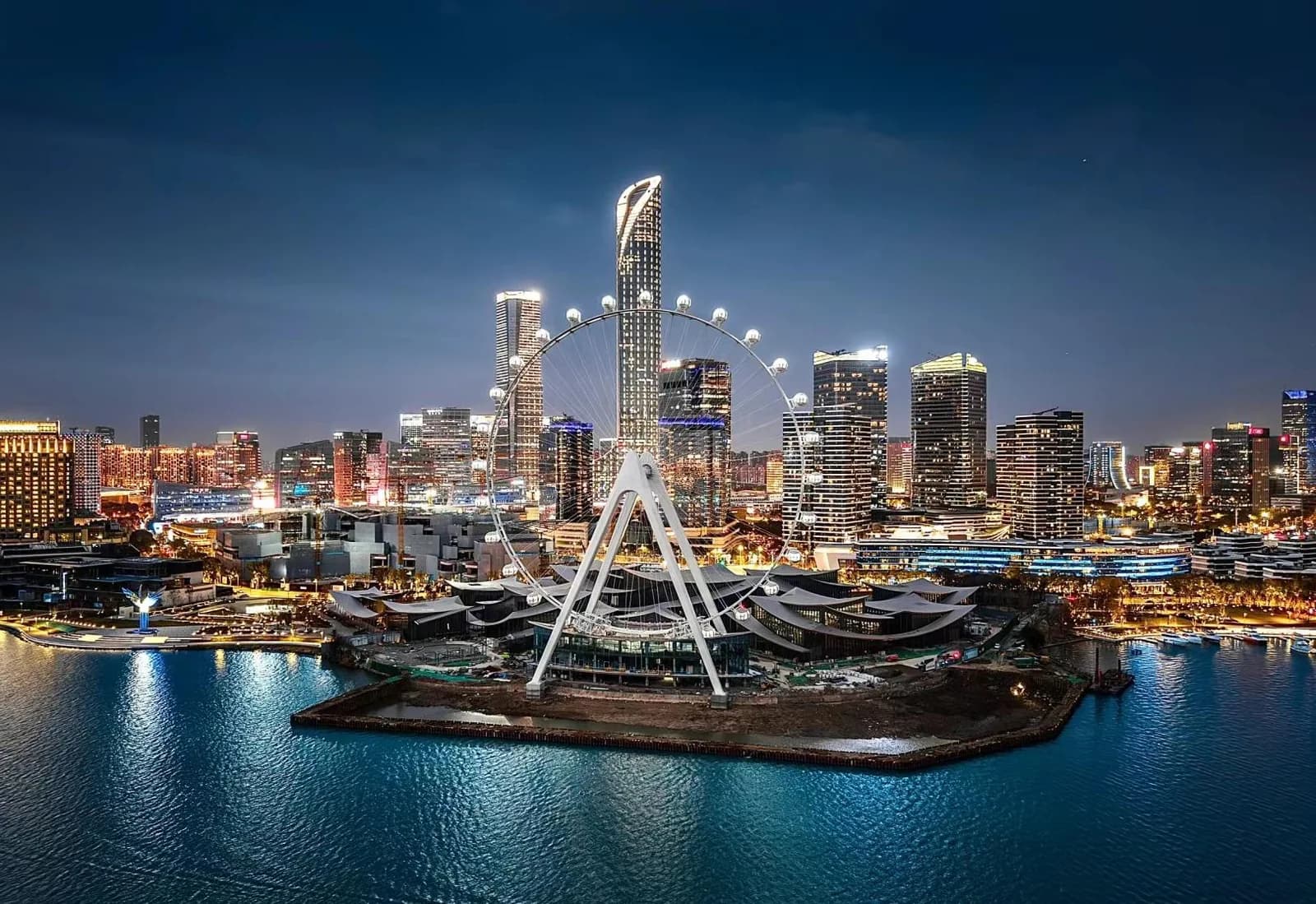 Suzhou Eye illuminated beside Jinji Lake and the city skyline